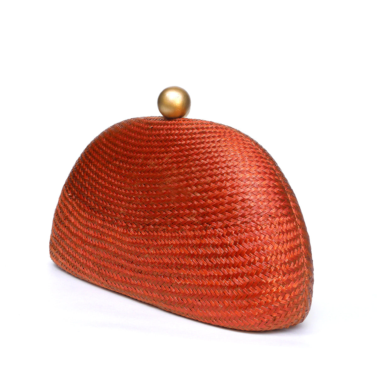 A woven oval clutch bag in a warm rust-orange color, featuring a small metallic gold dome clasp on top, set against a plain white background.