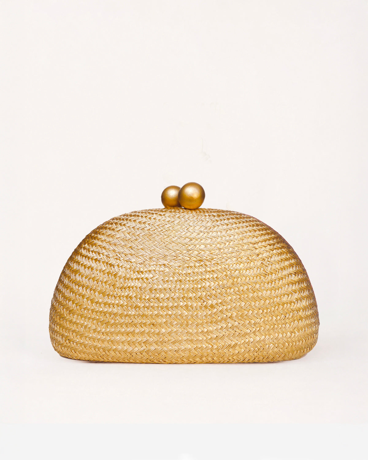 A woven straw dome clutch bag with a gold-tone wooden ball clasp  on a clean white background.