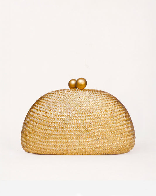 A woven straw dome clutch bag with a gold-tone wooden ball clasp  on a clean white background.