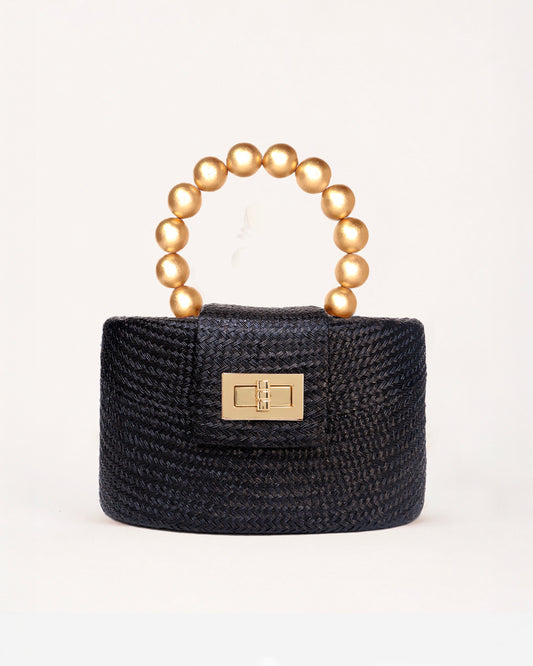 The Olivia black and gold woven straw top-handle bag with gold beaded handle, front view