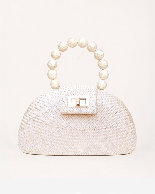 The Orla cream and pearl woven straw half-moon bag with pearl beaded handle, front view
